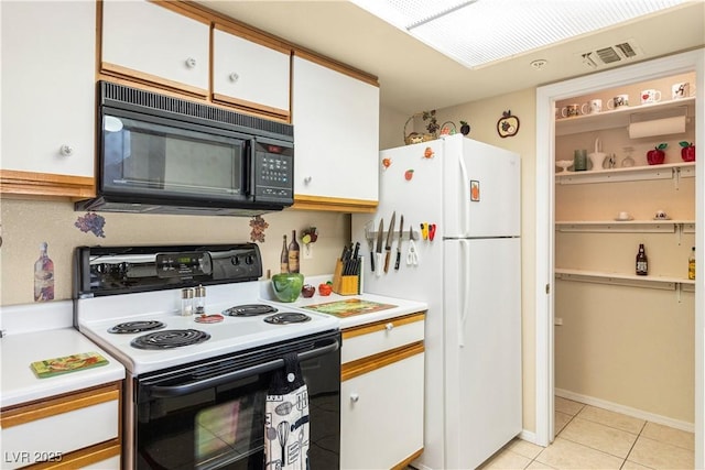 3550 Bay Sands Dr Unit 3096, Laughlin, NV 89029 - kitchen with range with electric stovetop, black microwave, freestanding refrigerator, light countertops, and white cabinets