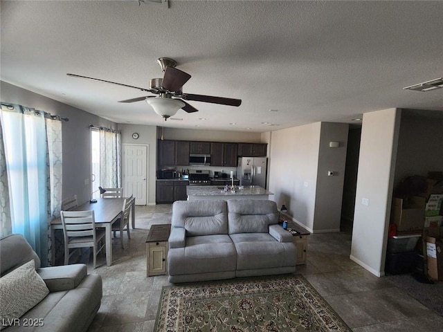 2682 Chinaberry Hill St, Laughlin, NV 89029 - living room featuring ceiling fan and a textured ceiling