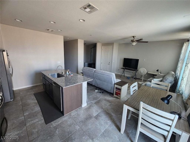 2682 Chinaberry Hill St, Laughlin, NV 89029 - kitchen featuring ceiling fan, appliances with stainless steel finishes, a kitchen island with sink, light stone countertops, and recessed lighting