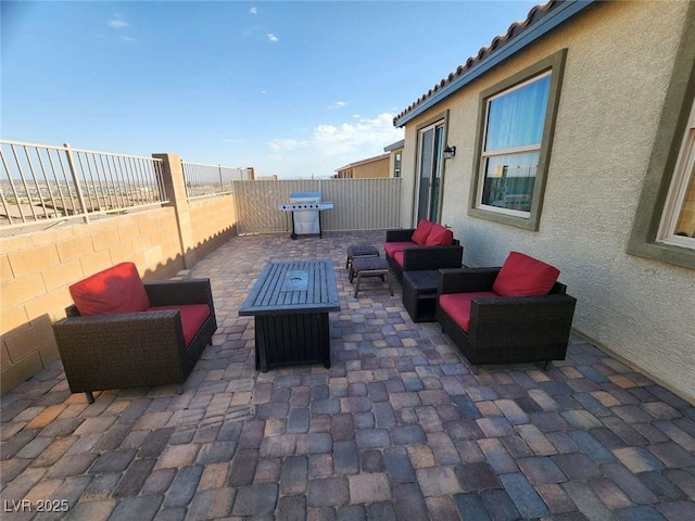 2682 Chinaberry Hill St, Laughlin, NV 89029 - fenced backyard featuring a patio, an outdoor living space with a fire pit, and area for grilling