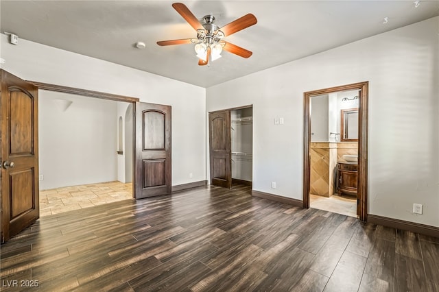7154 Ranchito Cir, Las Vegas, NV 89120 - unfurnished bedroom featuring dark wood-style flooring, a closet, a ceiling fan, and ensuite bathroom