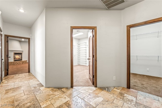 7154 Ranchito Cir, Las Vegas, NV 89120 - hall with stone tile flooring, light colored carpet, and recessed lighting