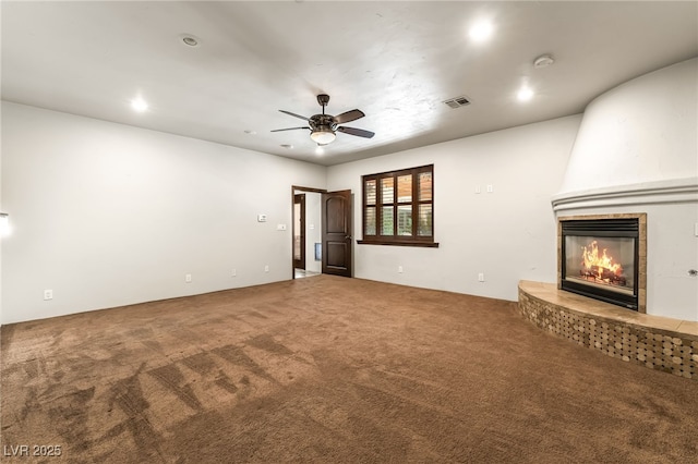 7154 Ranchito Cir, Las Vegas, NV 89120 - unfurnished living room with carpet flooring, a tiled fireplace, a ceiling fan, and recessed lighting