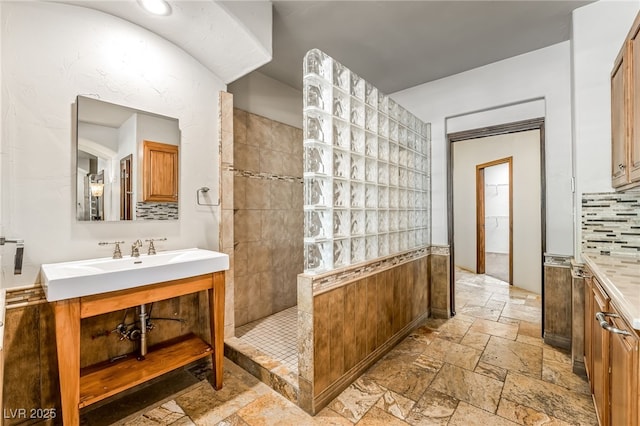 7154 Ranchito Cir, Las Vegas, NV 89120 - full bath with stone tile floors, vanity, a walk in shower, and backsplash