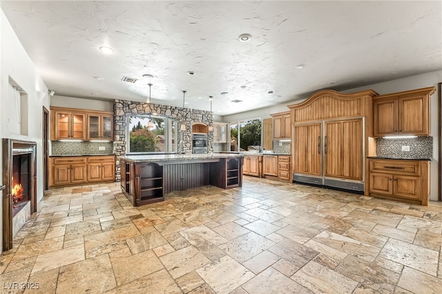 7154 Ranchito Cir, Las Vegas, NV 89120 - kitchen with paneled fridge, open shelves, decorative backsplash, brown cabinetry, and recessed lighting