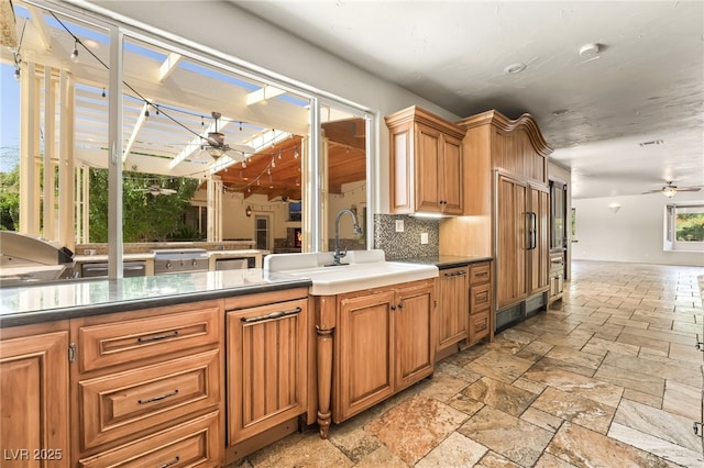 7154 Ranchito Cir, Las Vegas, NV 89120 - kitchen featuring ceiling fan, stone tile floors, tasteful backsplash, and open floor plan