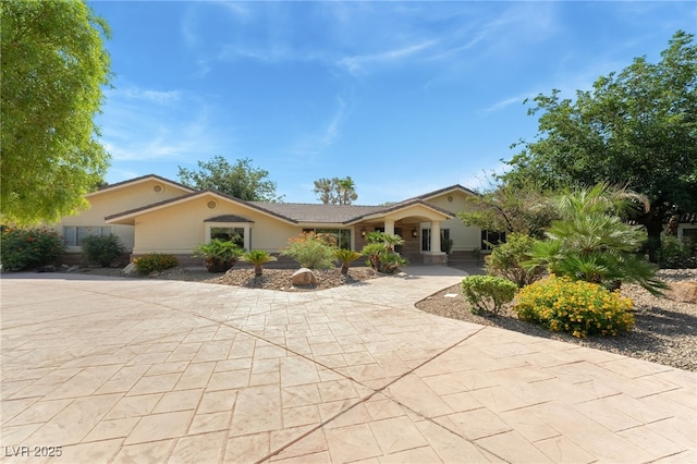 7154 Ranchito Cir, Las Vegas, NV 89120 - ranch-style home featuring stucco siding and curved driveway