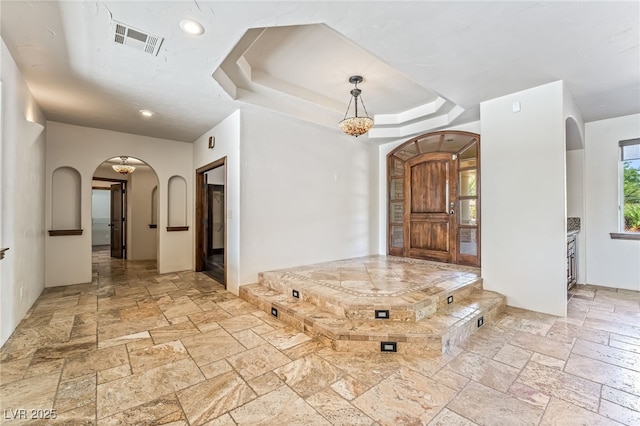 7154 Ranchito Cir, Las Vegas, NV 89120 - entrance foyer with arched walkways, stone tile flooring, a raised ceiling, and recessed lighting