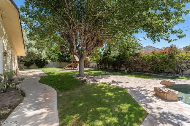 7154 Ranchito Cir, Las Vegas, NV 89120 - fenced backyard featuring a playground and a patio area