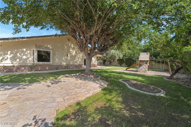 7154 Ranchito Cir, Las Vegas, NV 89120 - view of yard featuring a playground and a patio area