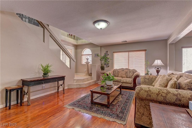 10978 Dornoch Castle St, Las Vegas, NV 89141 - living room featuring stairway, wood finished floors, and a textured ceiling
