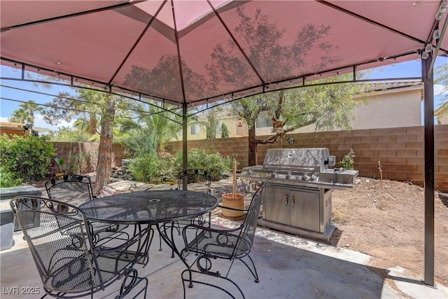 10978 Dornoch Castle St, Las Vegas, NV 89141 - fenced backyard with a gazebo, outdoor dining area, a patio, and a grill