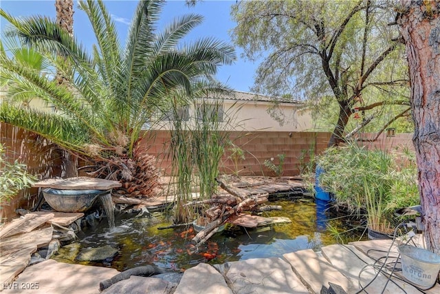 10978 Dornoch Castle St, Las Vegas, NV 89141 - fenced backyard featuring a small pond
