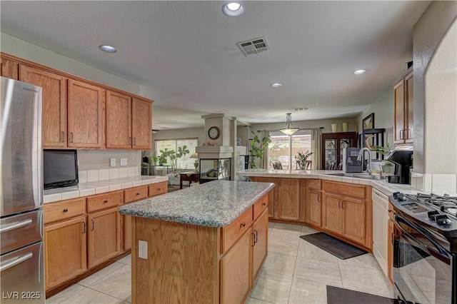 10978 Dornoch Castle St, Las Vegas, NV 89141 - kitchen featuring freestanding refrigerator, black gas stove, a peninsula, light tile patterned floors, and recessed lighting