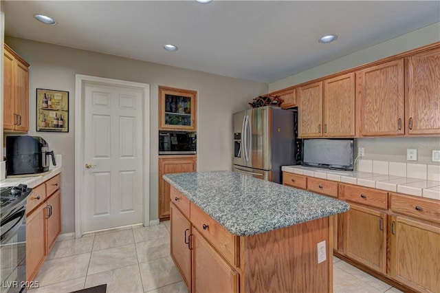 10978 Dornoch Castle St, Las Vegas, NV 89141 - kitchen featuring stainless steel appliances, a kitchen island, recessed lighting, light tile patterned floors, and light countertops