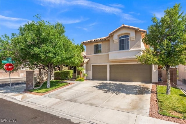 9794 Ice Box Canyon Ct, Las Vegas, NV 89117 - mediterranean / spanish home featuring stucco siding, an attached garage, a tiled roof, and driveway