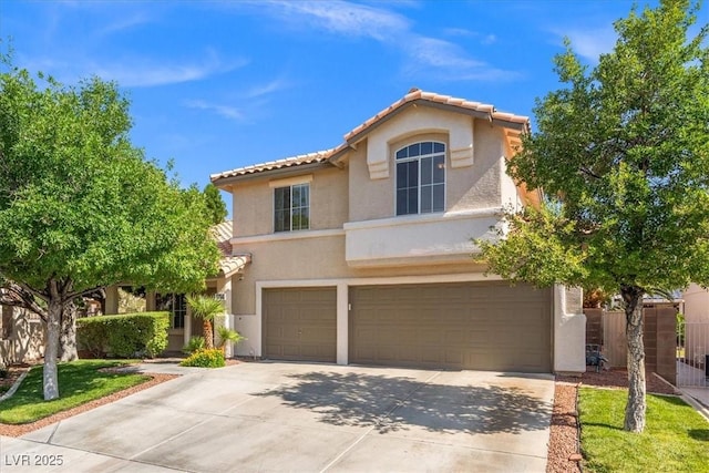 9794 Ice Box Canyon Ct, Las Vegas, NV 89117 - mediterranean / spanish-style home featuring a tile roof, stucco siding, an attached garage, and concrete driveway
