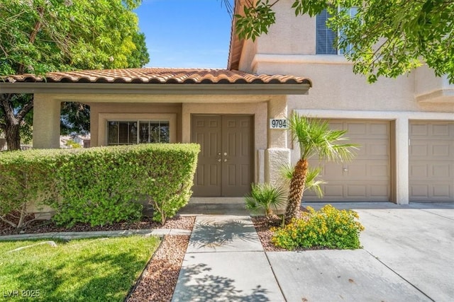 9794 Ice Box Canyon Ct, Las Vegas, NV 89117 - property entrance with stucco siding, a tile roof, and an attached garage