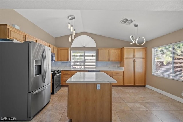 9794 Ice Box Canyon Ct, Las Vegas, NV 89117 - kitchen with appliances with stainless steel finishes, lofted ceiling, light countertops, backsplash, and pendant lighting