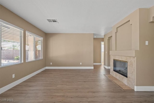 9794 Ice Box Canyon Ct, Las Vegas, NV 89117 - unfurnished living room featuring wood finished floors and a premium fireplace