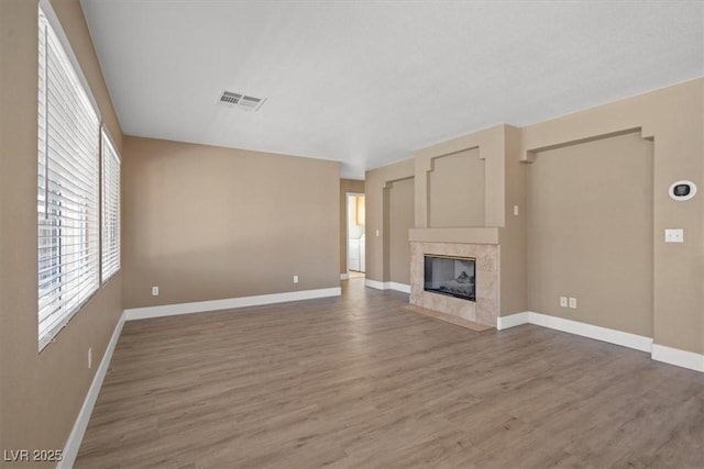 9794 Ice Box Canyon Ct, Las Vegas, NV 89117 - unfurnished living room with wood finished floors and a tile fireplace