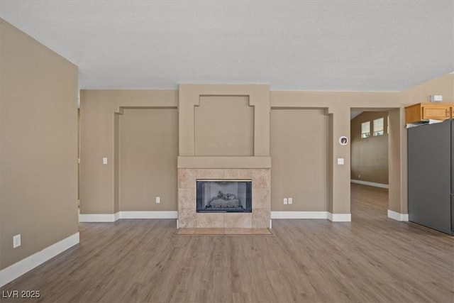 9794 Ice Box Canyon Ct, Las Vegas, NV 89117 - unfurnished living room featuring wood finished floors and a fireplace
