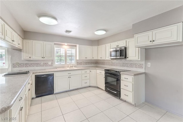 2780 Montessouri St, Las Vegas, NV 89117 - kitchen featuring black appliances, tasteful backsplash, light countertops, and white cabinetry
