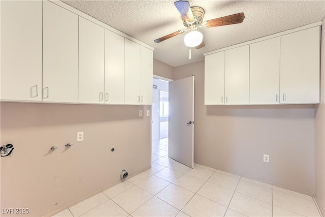 2780 Montessouri St, Las Vegas, NV 89117 - laundry area with cabinet space, electric dryer hookup, ceiling fan, a textured ceiling, and light tile patterned flooring