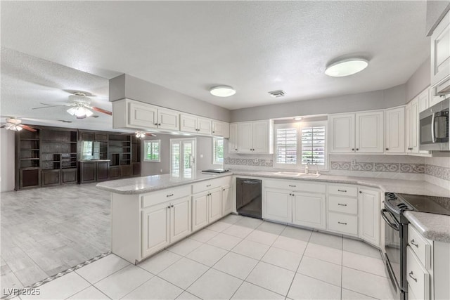 2780 Montessouri St, Las Vegas, NV 89117 - kitchen with black appliances, a peninsula, a ceiling fan, healthy amount of natural light, and a textured ceiling