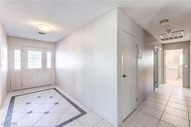 2780 Montessouri St, Las Vegas, NV 89117 - foyer with a textured ceiling, light tile patterned floors, and healthy amount of natural light