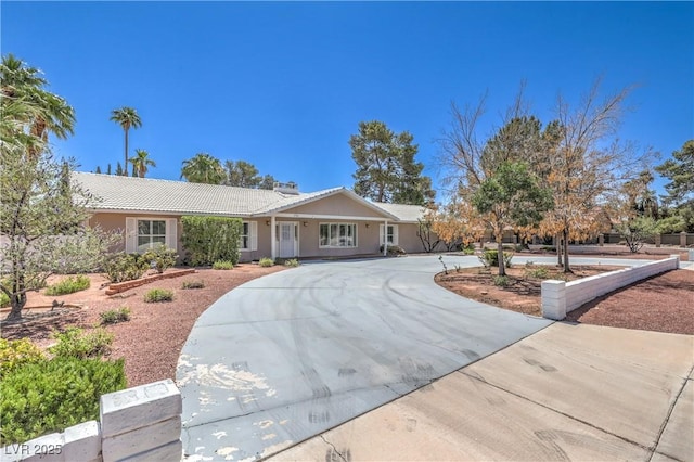 2780 Montessouri St, Las Vegas, NV 89117 - ranch-style house with curved driveway, a tile roof, and stucco siding