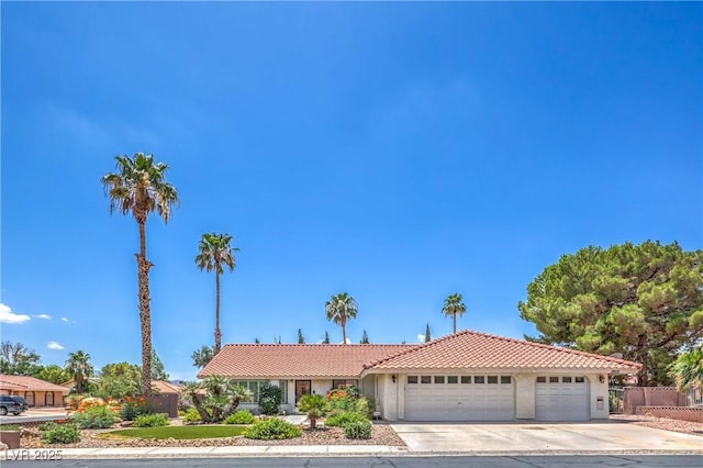 1605 Siboney Dr, Las Vegas, NV 89123 - view of front of property featuring an attached garage, a tile roof, concrete driveway, and stucco siding