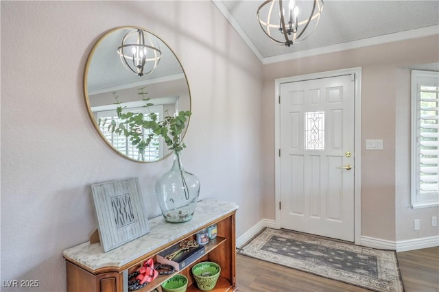 1605 Siboney Dr, Las Vegas, NV 89123 - foyer featuring a chandelier, wood finished floors, plenty of natural light, vaulted ceiling, and crown molding
