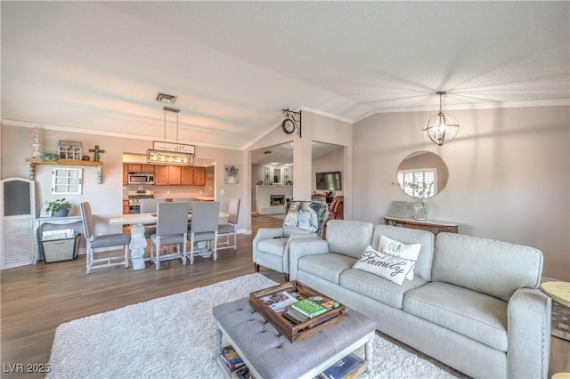 1605 Siboney Dr, Las Vegas, NV 89123 - living room featuring crown molding, dark wood-type flooring, vaulted ceiling, and a chandelier
