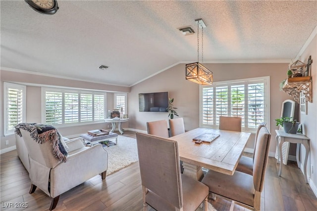 1605 Siboney Dr, Las Vegas, NV 89123 - dining room featuring wood finished floors, lofted ceiling, a textured ceiling, and ornamental molding