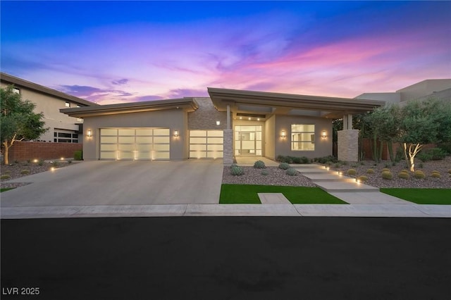 11 Hawkeye Ln, Las Vegas, NV 89135 - view of front of home featuring stucco siding, an attached garage, and concrete driveway