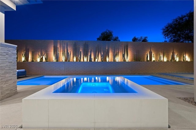 11 Hawkeye Ln, Las Vegas, NV 89135 - view of swimming pool featuring a fenced backyard and a pool with connected hot tub