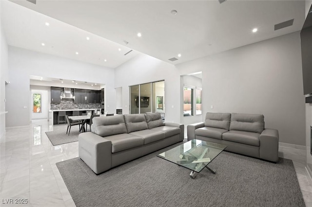 11 Hawkeye Ln, Las Vegas, NV 89135 - living room featuring light marble finish floors, recessed lighting, and high vaulted ceiling