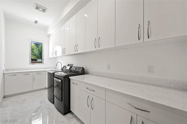 11 Hawkeye Ln, Las Vegas, NV 89135 - laundry room featuring cabinet space, light marble finish flooring, and washer and clothes dryer