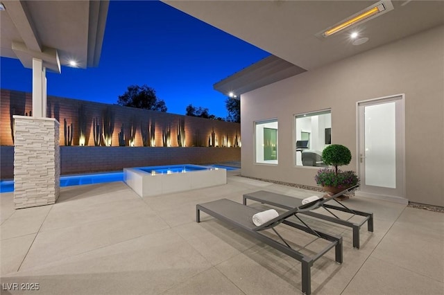 11 Hawkeye Ln, Las Vegas, NV 89135 - pool at night with a patio, an outdoor pool, and a fenced backyard