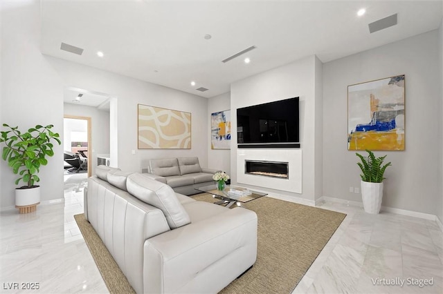11 Hawkeye Ln, Las Vegas, NV 89135 - living room featuring marble tiled floors, recessed lighting, and a glass covered fireplace
