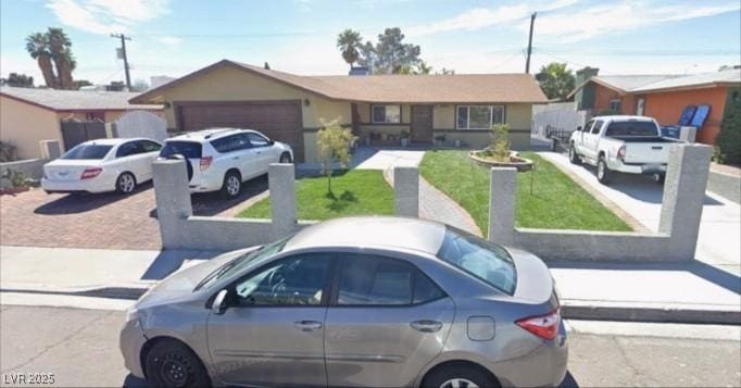 4989 Via De Palma Dr, Las Vegas, NV 89146 - ranch-style house with an attached garage, a front lawn, and driveway