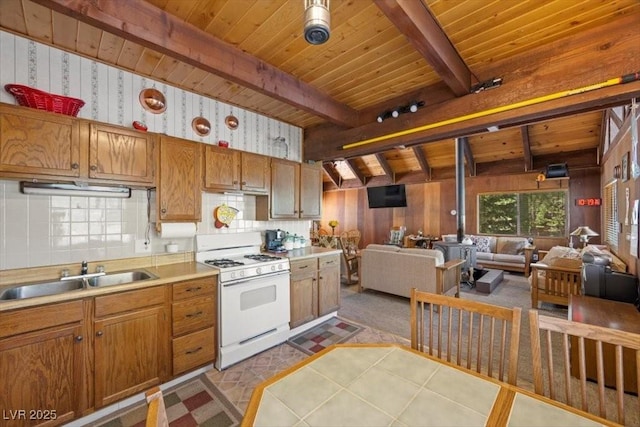 2169 Via Spes Nostra St, Mount Charleston, NV 89124 - kitchen featuring white gas range oven, a wood ceiling with exposed beams, open floor plan, light countertops, and backsplash