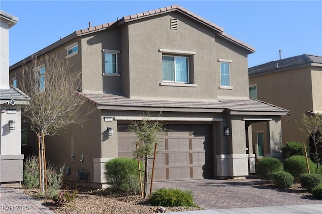 7022 Judith River St, North Las Vegas, NV 89084 - view of front of property with a garage, stucco siding, decorative driveway, and a tile roof