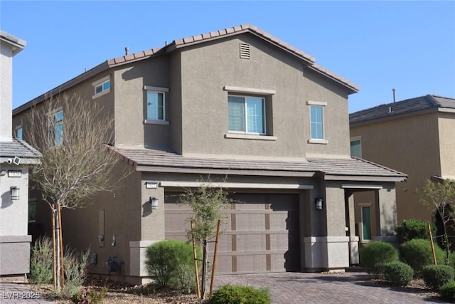7022 Judith River St, North Las Vegas, NV 89084 - view of front facade featuring a garage, stucco siding, driveway, and a tiled roof