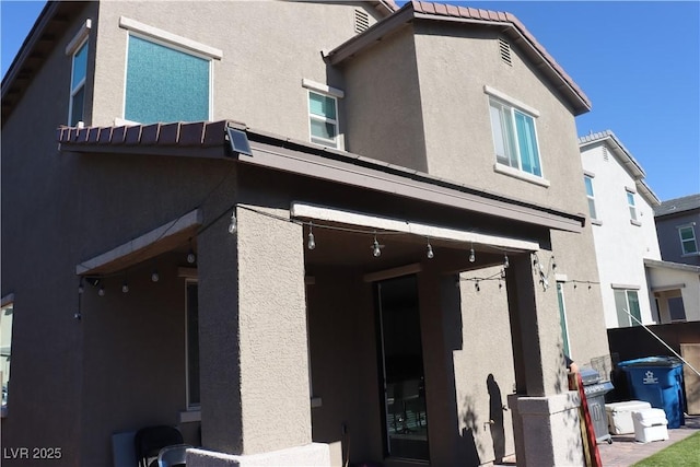 7022 Judith River St, North Las Vegas, NV 89084 - rear view of property featuring stucco siding and a tile roof