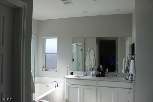 7022 Judith River St, North Las Vegas, NV 89084 - full bathroom with a garden tub, double vanity, and a stall shower