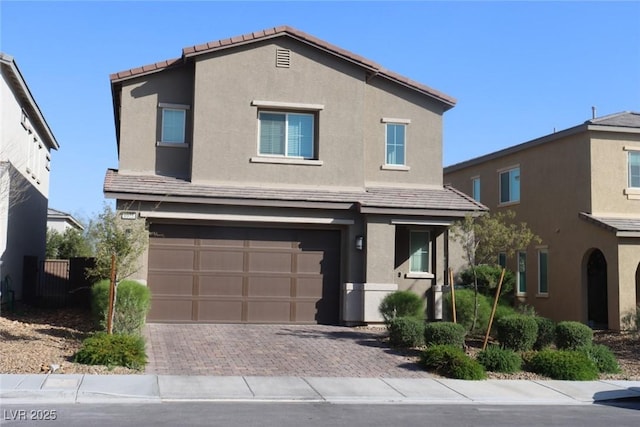 7022 Judith River St, North Las Vegas, NV 89084 - view of front of property with an attached garage, stucco siding, decorative driveway, and a tiled roof