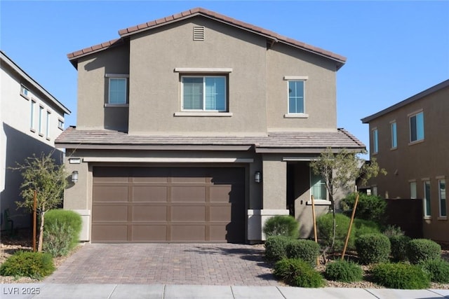 7022 Judith River St, North Las Vegas, NV 89084 - view of front facade featuring decorative driveway, a garage, stucco siding, and a tiled roof
