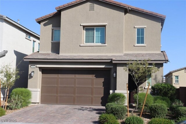 7022 Judith River St, North Las Vegas, NV 89084 - view of front of property with an attached garage, decorative driveway, stucco siding, and a tile roof